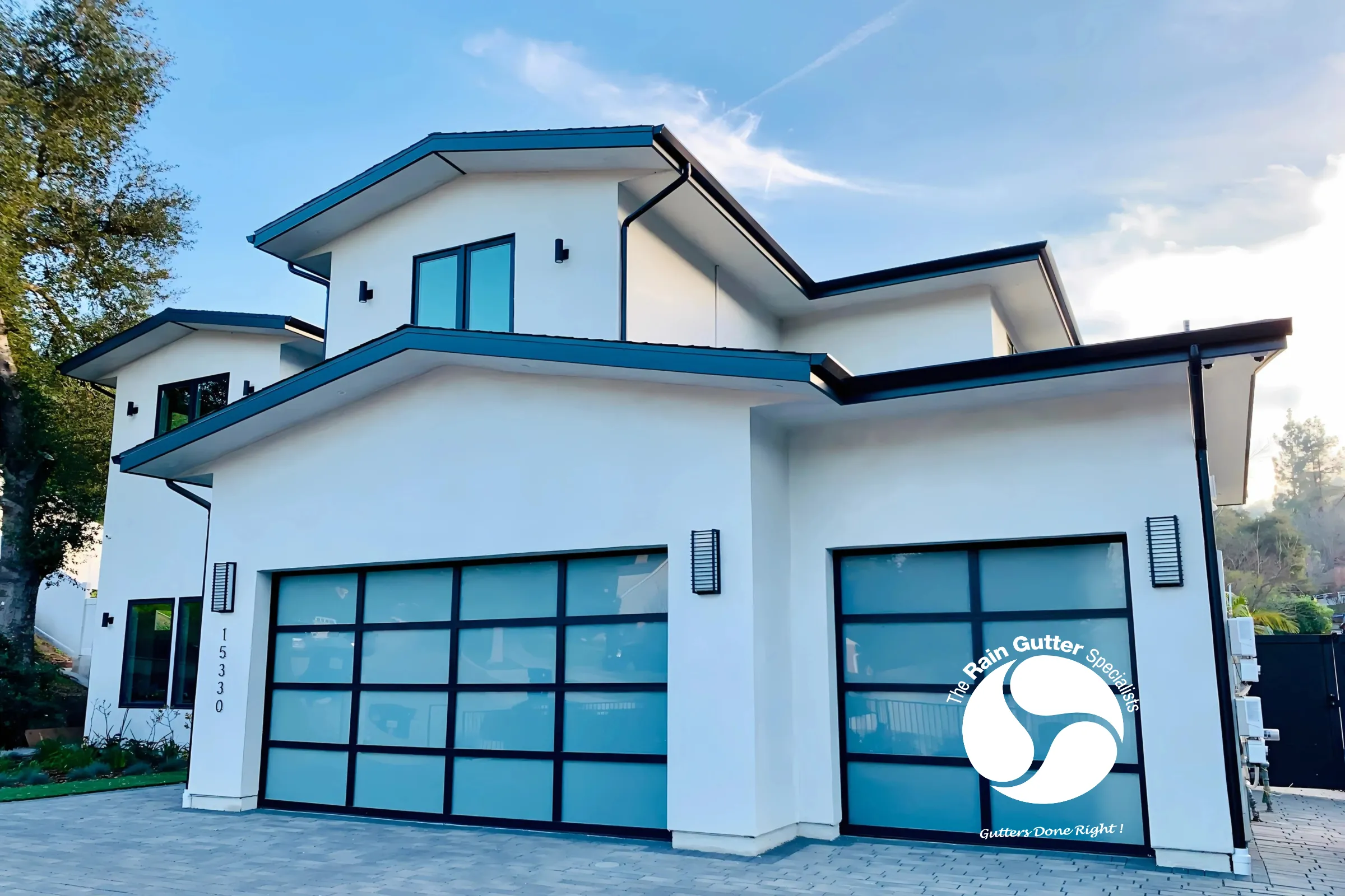 Modern white home with black downspouts