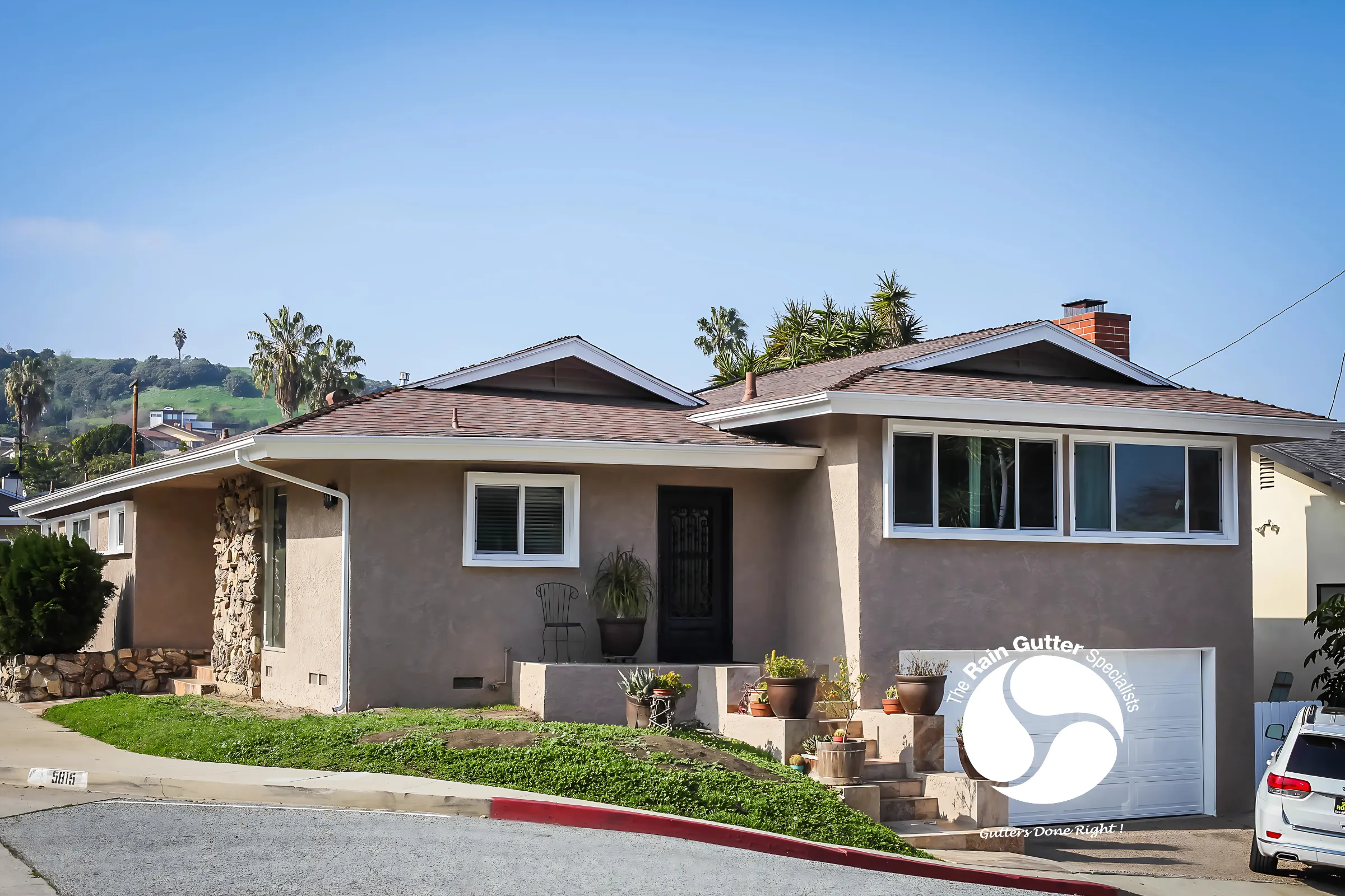 Newly installed white seamless gutter shown up close